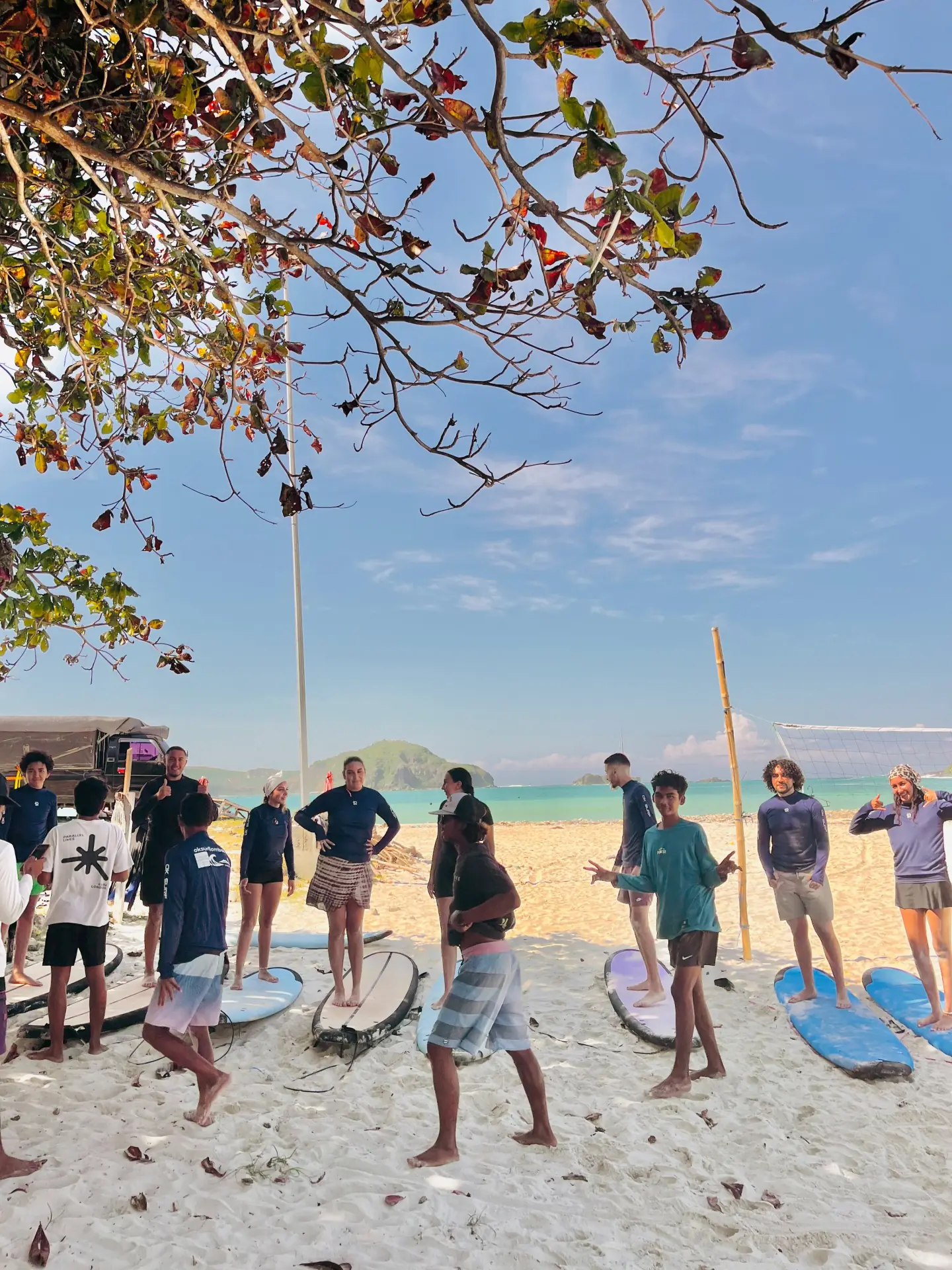 Students warming up together on the beach