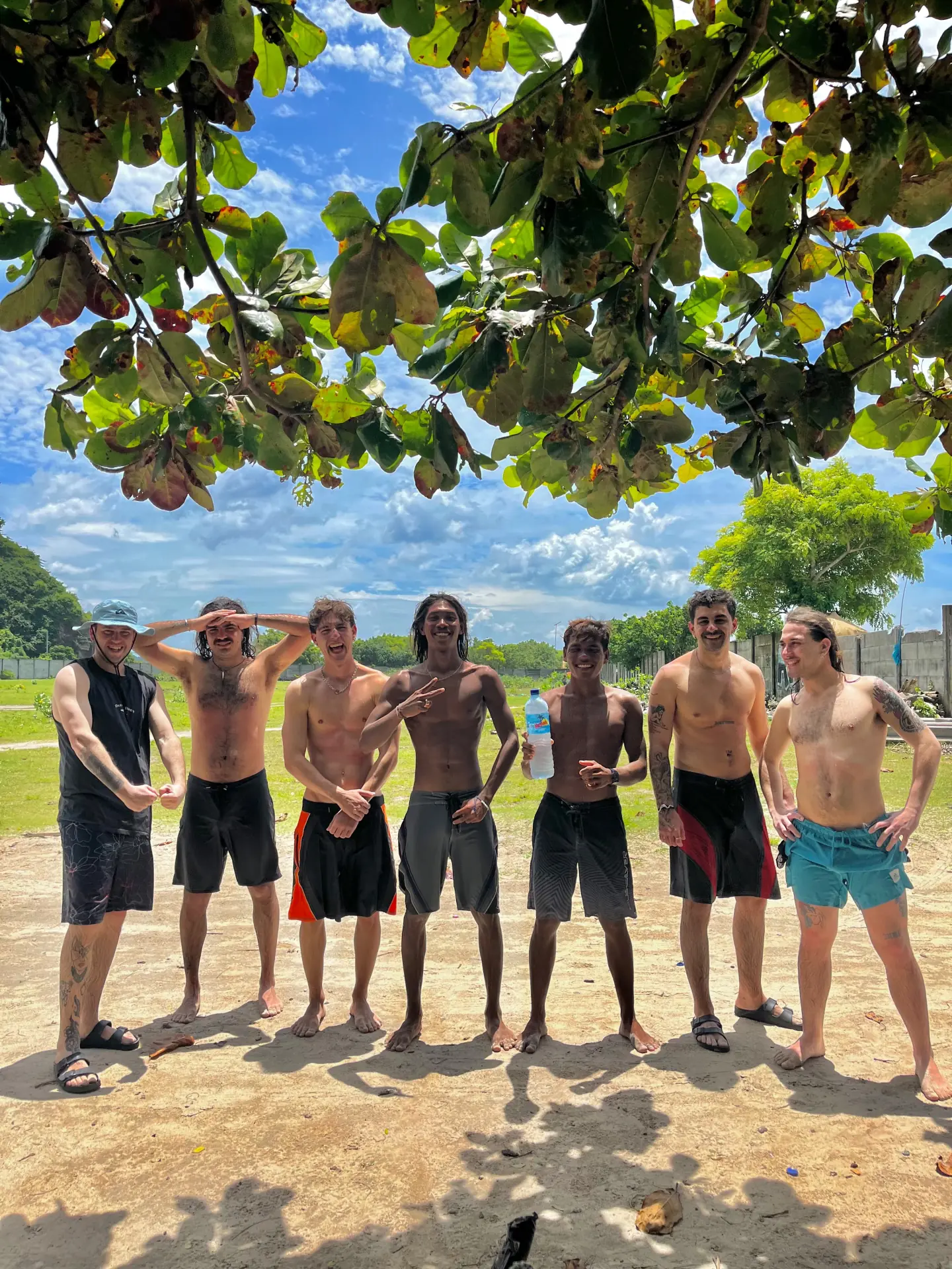 A group of surfers smiling after their lesson
