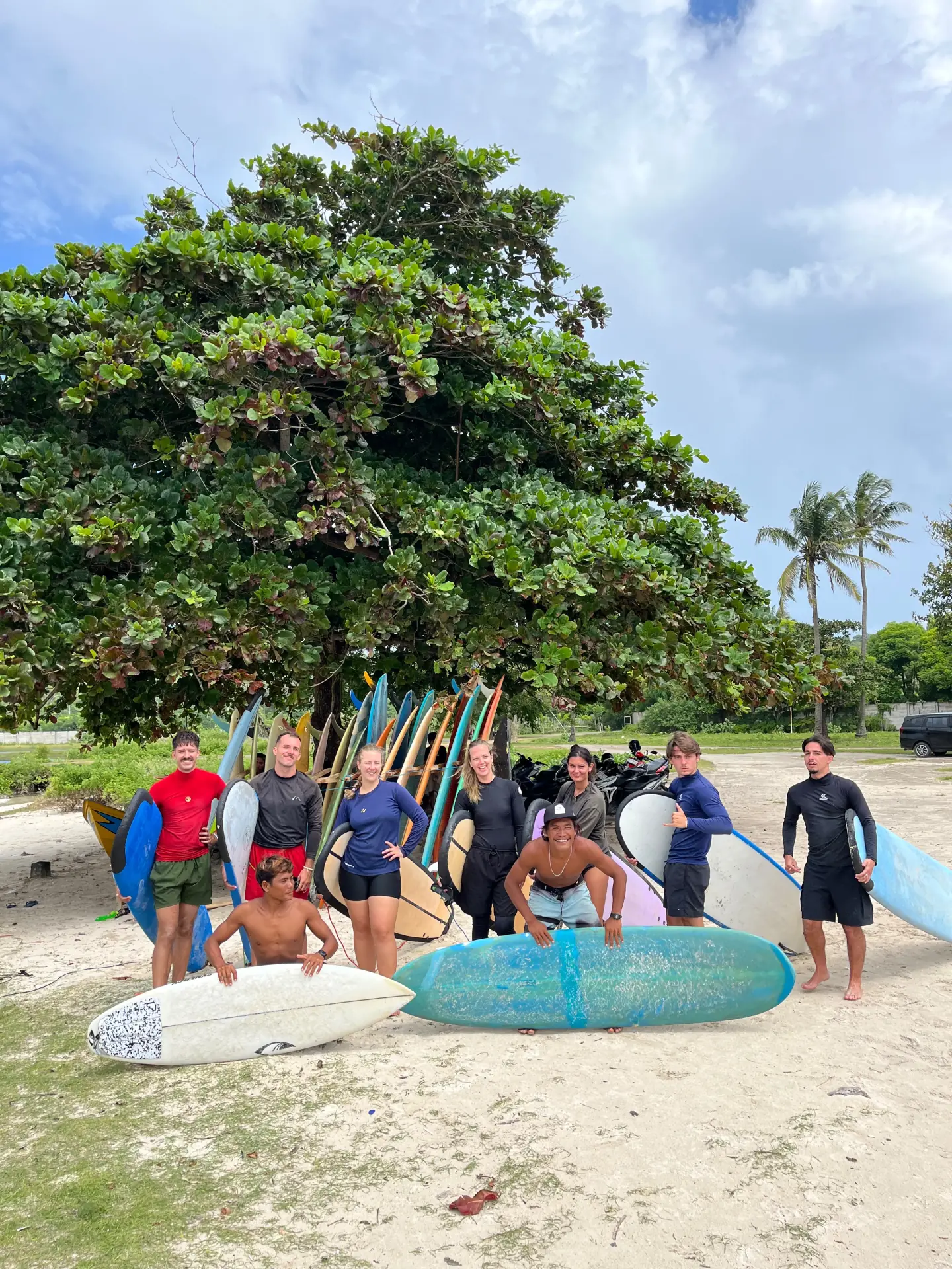 A happy group of surfers and coaches after a session
